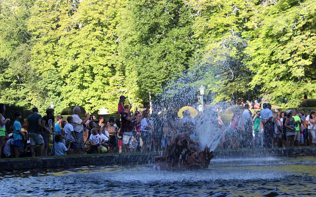 Visitors watching a fountain display in the gardens of La Granja
